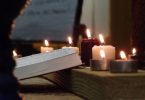 Bible and lit candles