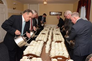 men filling coffee cups for lovefeast