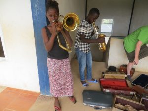 girl playing trombone in Sierra Leone