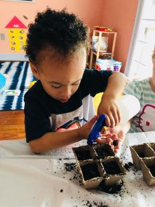 child planting seeds