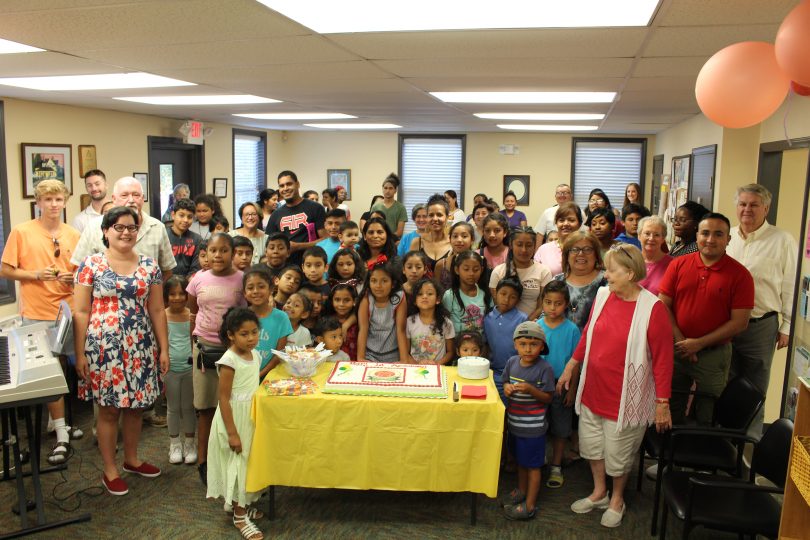 children around a cake