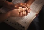 hand-holding over bible