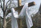 cross with white cloth draped over