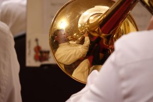 reflection of trombone player in brass
