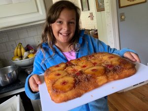 child baking upside down pineapple cake
