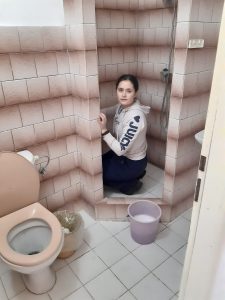 person cleaning a bathroom